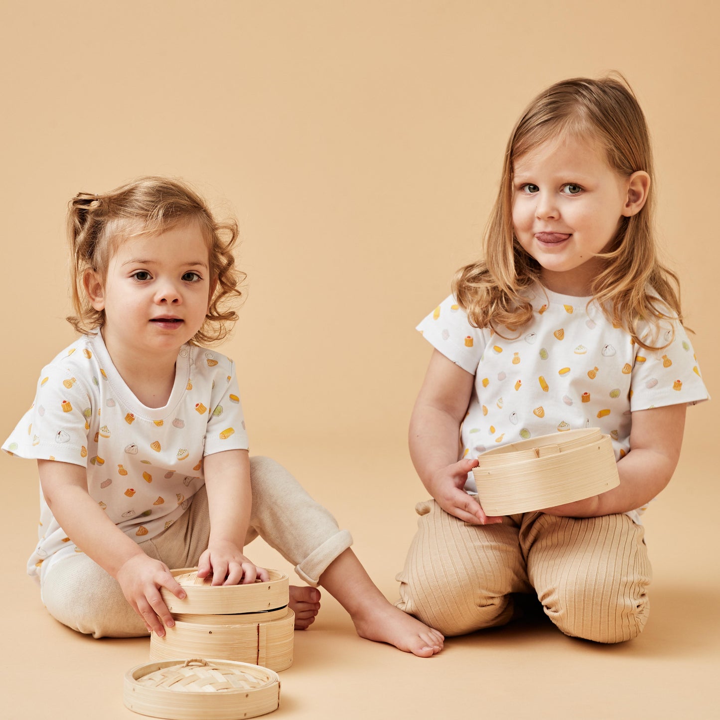 Girls wearing a colourful Dim Sum kids tshirt with a steamer bun basket