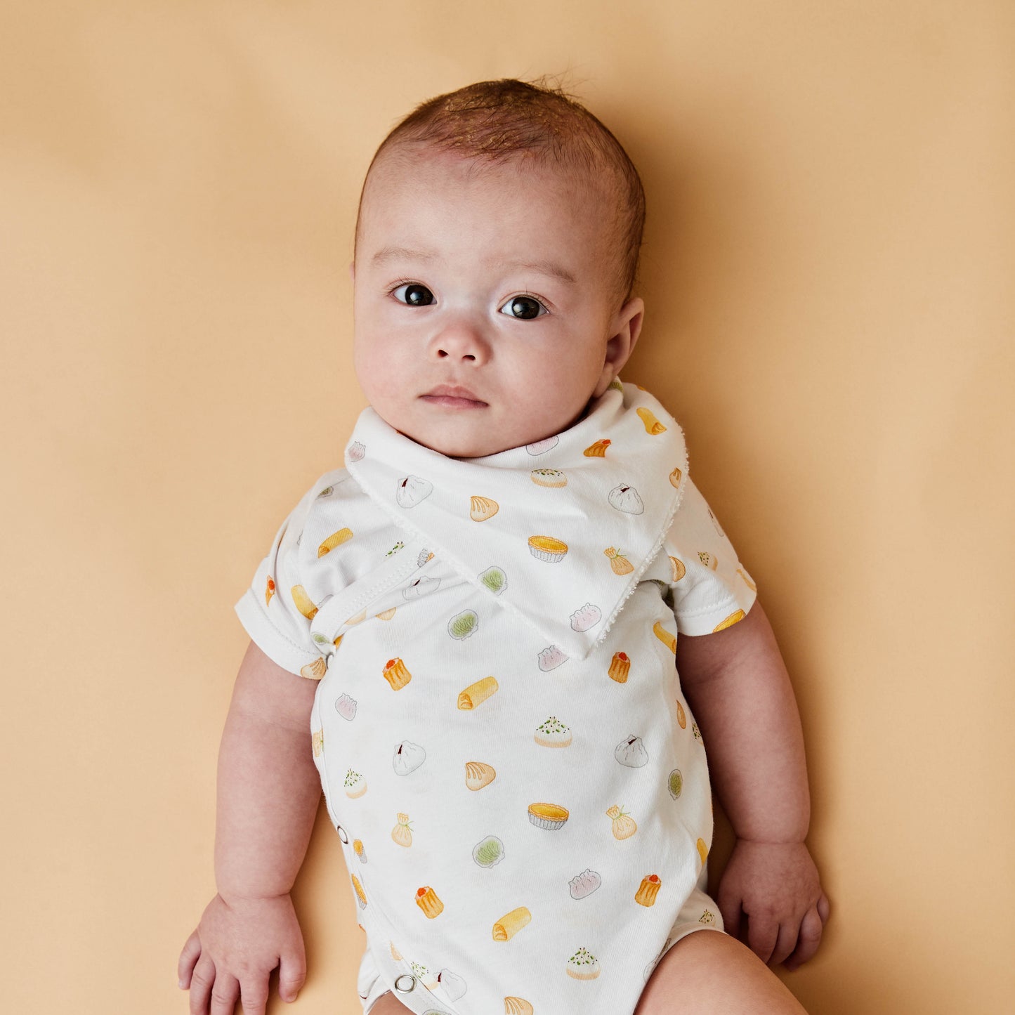 Baby with dim sum inspired bodysuit and bib