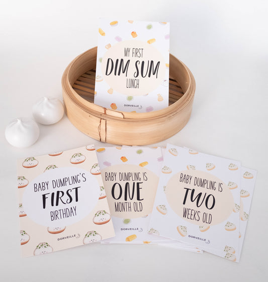 Dim Sum inspired baby milestone cards in a steamer basket
