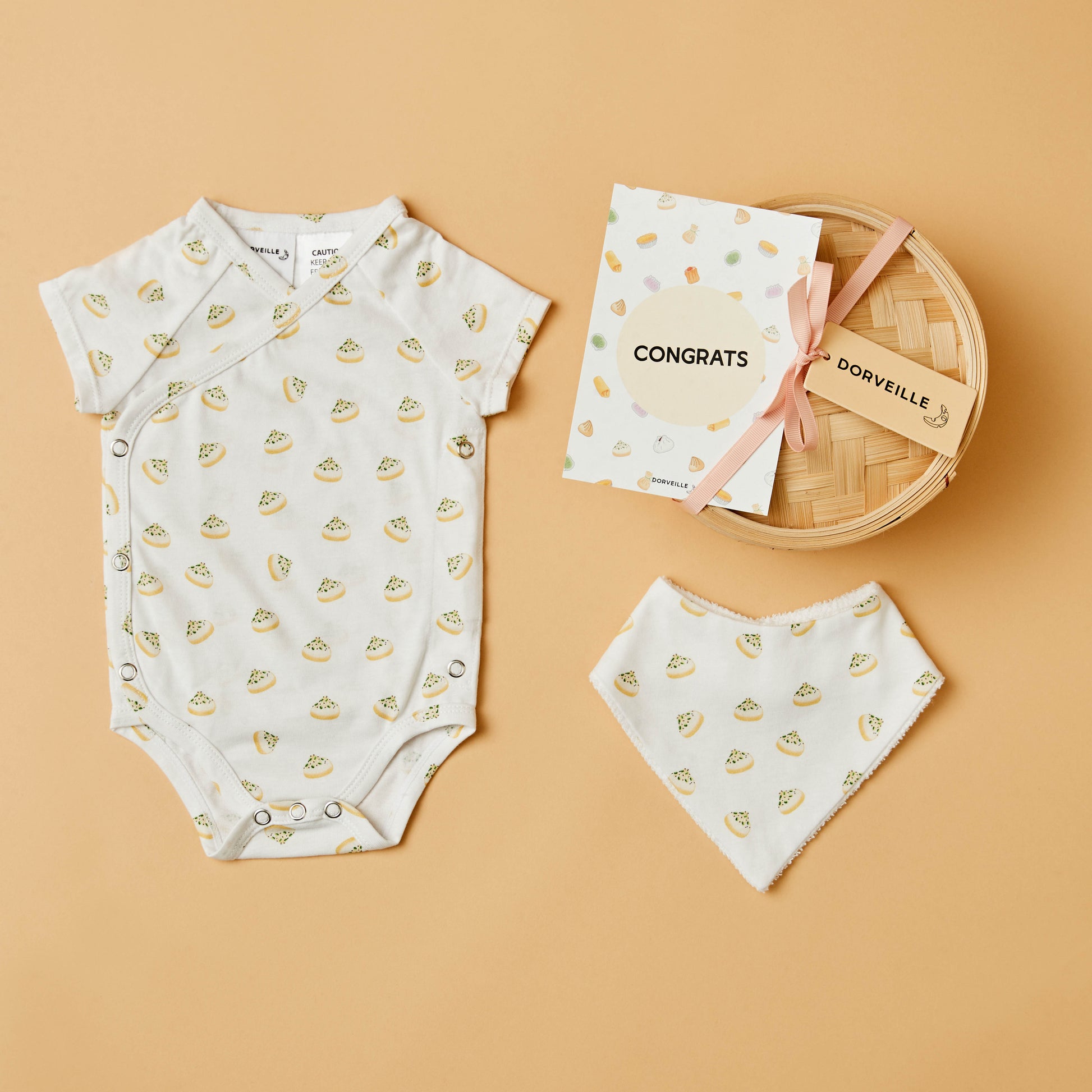 Dumpling inspired baby bodysuit, matching bib, Congrats postcard and a Bamboo Steamer Basket with pink ribbon